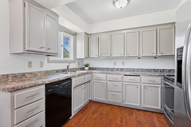 kitchen with a sink, stainless steel appliances, and dark wood-style flooring