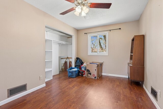 bedroom featuring visible vents, wood finished floors, and a closet