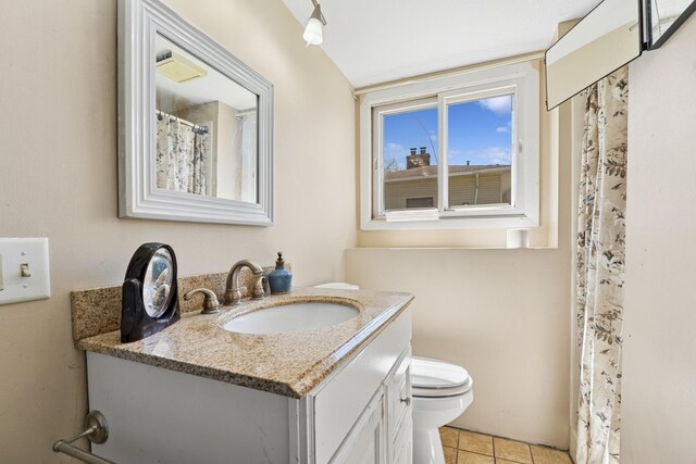 full bathroom with vanity, tile patterned floors, and toilet