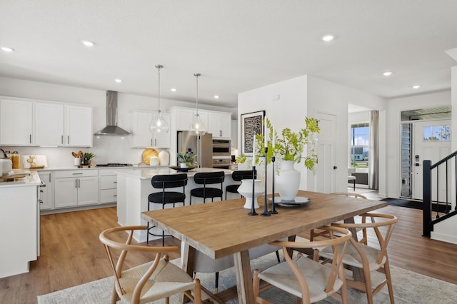 dining area featuring recessed lighting and light wood-style flooring