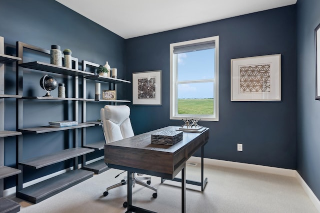 carpeted home office featuring baseboards