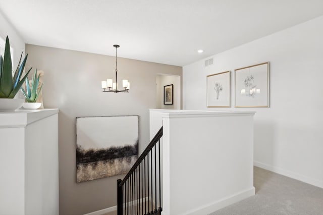 stairway featuring visible vents, baseboards, a notable chandelier, carpet, and recessed lighting