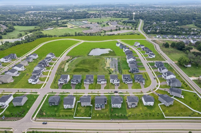 birds eye view of property with a water view and a residential view