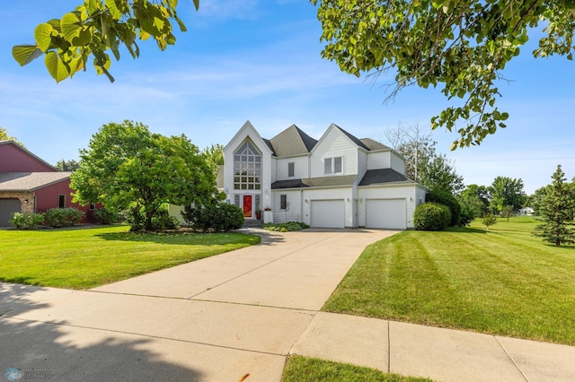 view of front facade featuring a shingled roof, driveway, a front yard, and a garage