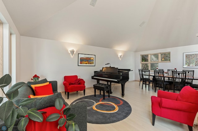 living area with lofted ceiling and wood finished floors