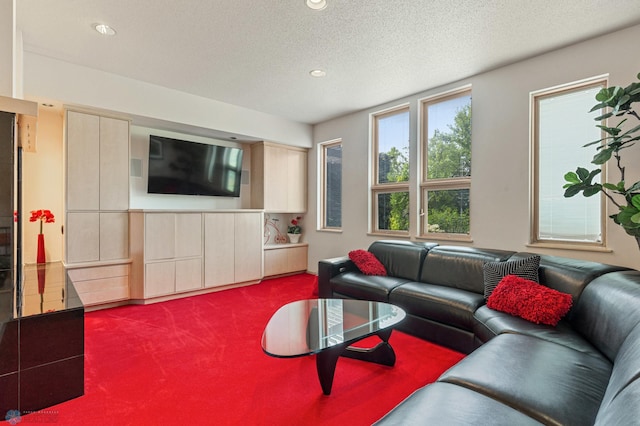 carpeted living room featuring recessed lighting and a textured ceiling