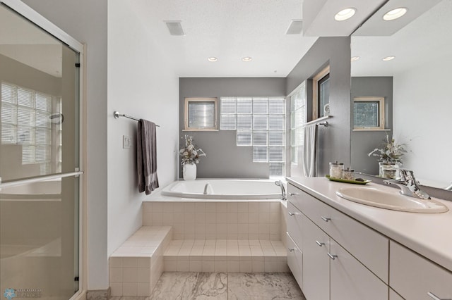 full bath with vanity, recessed lighting, a shower stall, visible vents, and a bath