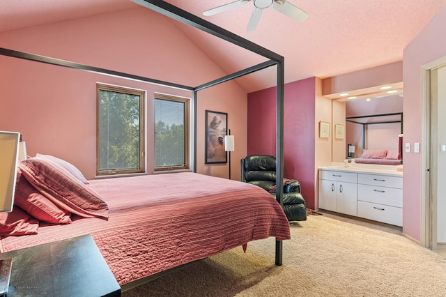 bedroom with connected bathroom, vaulted ceiling, a ceiling fan, and light colored carpet