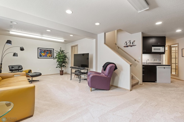 living area with light carpet, stairs, recessed lighting, and a textured ceiling