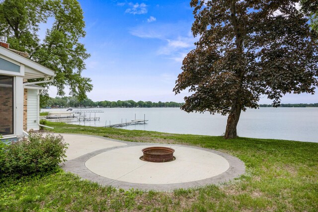21370 654th Ave, Darwin, MN 55324 - view of grassy yard featuring a fire pit, a water view, and a patio