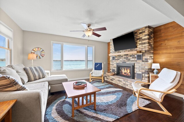 21370 654th Ave, Darwin, MN 55324 - living area with ceiling fan, a fireplace, wood finished floors, baseboards, and wood walls