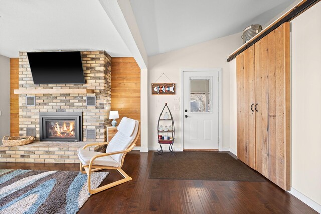 21370 654th Ave, Darwin, MN 55324 - entrance foyer featuring hardwood / wood-style floors, vaulted ceiling, a brick fireplace, and baseboards