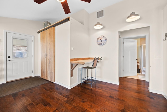 21370 654th Ave, Darwin, MN 55324 - entrance foyer with hardwood / wood-style flooring, a ceiling fan, baseboards, and a barn door