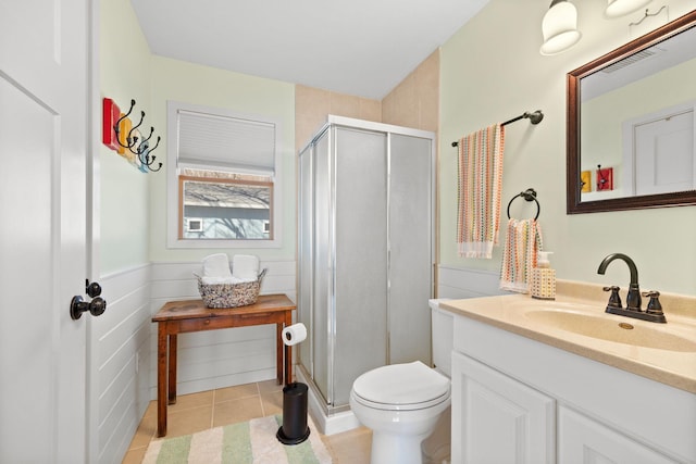 21370 654th Ave, Darwin, MN 55324 - full bathroom featuring vanity, a stall shower, toilet, tile patterned flooring, and wainscoting