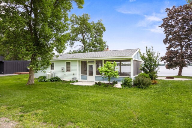 21370 654th Ave, Darwin, MN 55324 - view of front of property with a sunroom, a front lawn, and a shingled roof