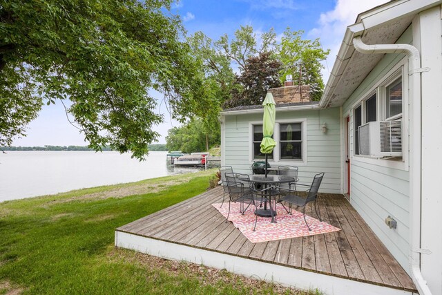 21370 654th Ave, Darwin, MN 55324 - wooden terrace featuring a water view, outdoor dining space, a lawn, and cooling unit