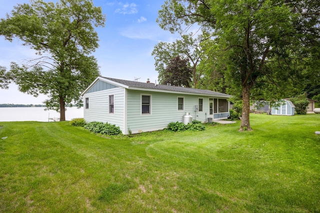 21370 654th Ave, Darwin, MN 55324 - rear view of house featuring a sunroom, a yard, a water view, and board and batten siding