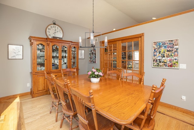 32337 Juniper Rd, Chatfield, MN 55923 - dining room featuring light wood-style flooring, vaulted ceiling, a chandelier, baseboards, and ornamental molding
