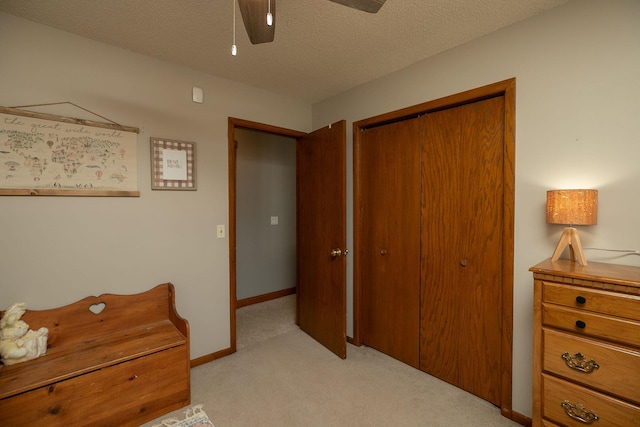 32337 Juniper Rd, Chatfield, MN 55923 - bedroom featuring light colored carpet, a closet, a ceiling fan, a textured ceiling, and baseboards