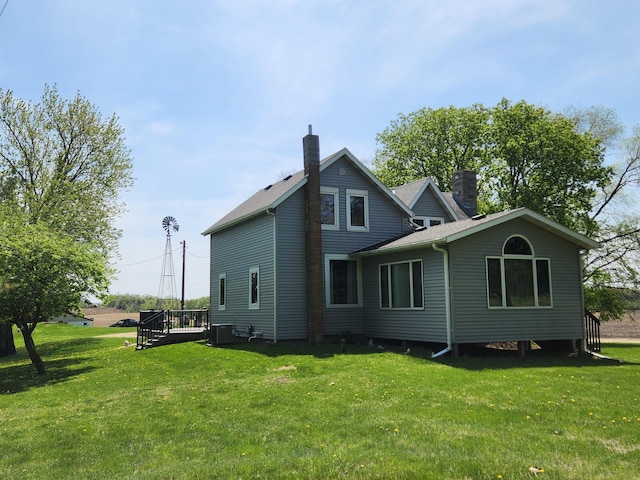6200 37th St W, Webster, MN 55088 - rear view of house featuring a chimney, a yard, and cooling unit