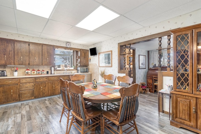 6200 37th St W, Webster, MN 55088 - dining room featuring a paneled ceiling, light wood finished floors, and wallpapered walls