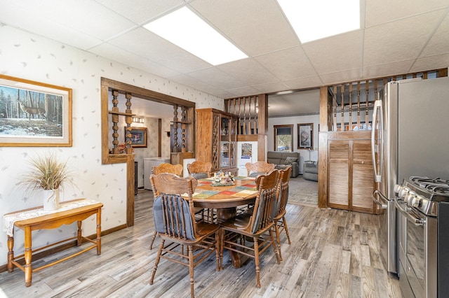 6200 37th St W, Webster, MN 55088 - dining area with a paneled ceiling, light wood-style floors, baseboards, and wallpapered walls