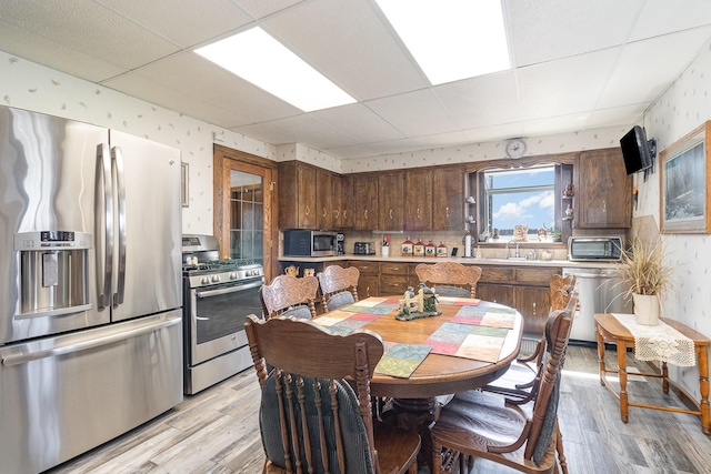6200 37th St W, Webster, MN 55088 - kitchen featuring stainless steel appliances, a drop ceiling, light wood finished floors, light countertops, and dark brown cabinets
