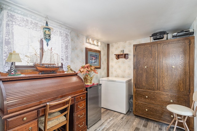 6200 37th St W, Webster, MN 55088 - laundry area featuring wallpapered walls, light wood finished floors, and a desk