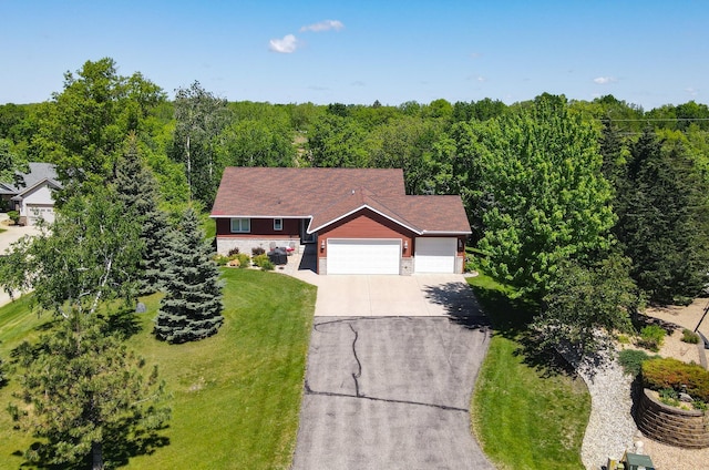 122 Ridge Rd, New London, MN 56273 - view of front facade featuring driveway, an attached garage, and stone siding