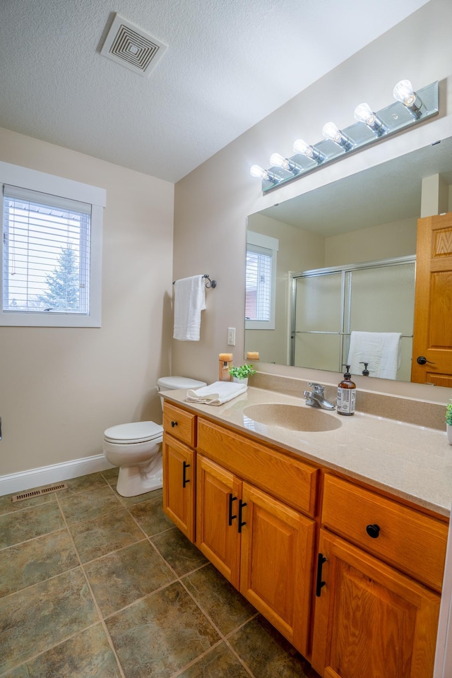 122 Ridge Rd, New London, MN 56273 - bathroom featuring vanity, a shower stall, toilet, baseboards, and tile patterned floors