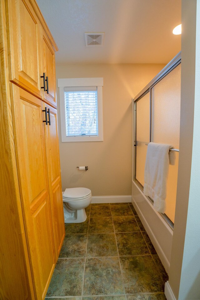 122 Ridge Rd, New London, MN 56273 - full bathroom with toilet, shower / bath combination with glass door, and baseboards