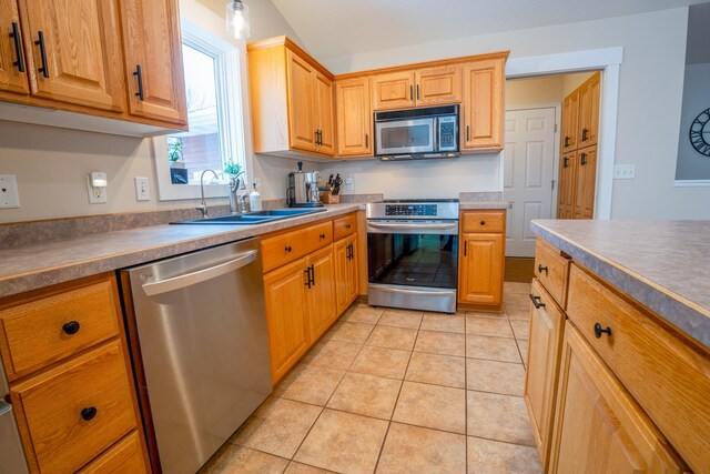 122 Ridge Rd, New London, MN 56273 - kitchen with stainless steel appliances, a sink, and light tile patterned flooring