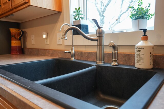 122 Ridge Rd, New London, MN 56273 - kitchen view of a sink and brown cabinets