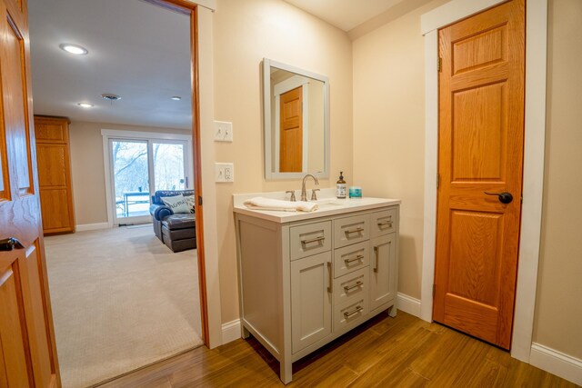 122 Ridge Rd, New London, MN 56273 - bathroom with vanity, baseboards, wood finished floors, and recessed lighting