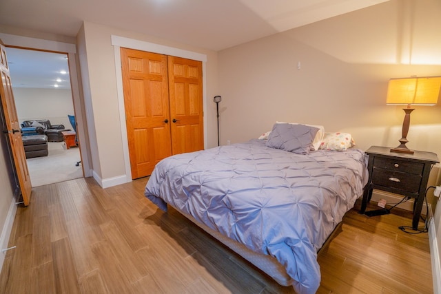 122 Ridge Rd, New London, MN 56273 - bedroom featuring wood finished floors, a closet, and baseboards