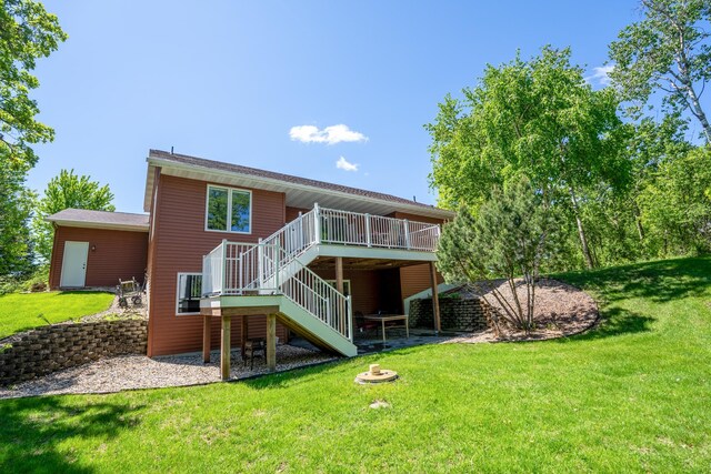122 Ridge Rd, New London, MN 56273 - back of house featuring stairway, a deck, and a lawn