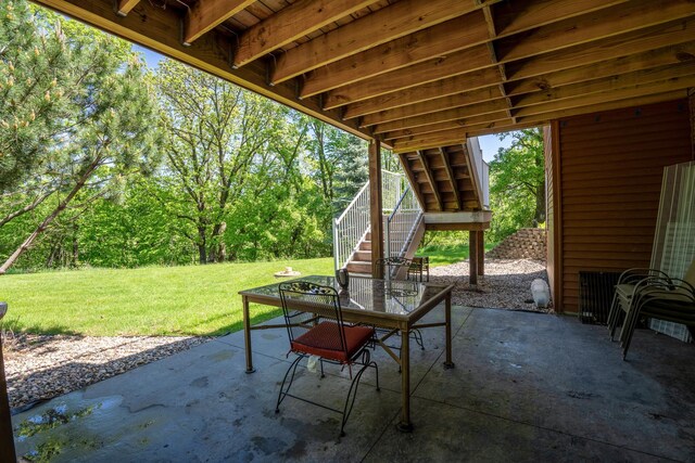 122 Ridge Rd, New London, MN 56273 - view of patio featuring stairway and outdoor dining area
