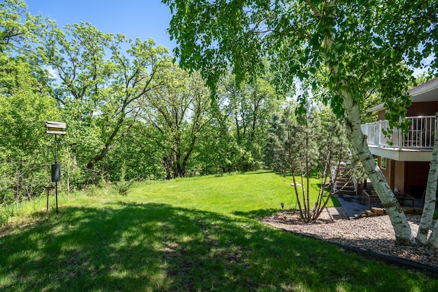 122 Ridge Rd, New London, MN 56273 - view of grassy yard featuring a wooden deck and stairs