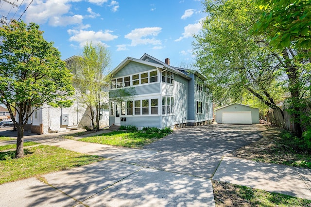 560 Stryker Ave, Saint Paul, MN 55107 - view of front of home featuring a chimney, entry steps, an outbuilding, and a detached garage