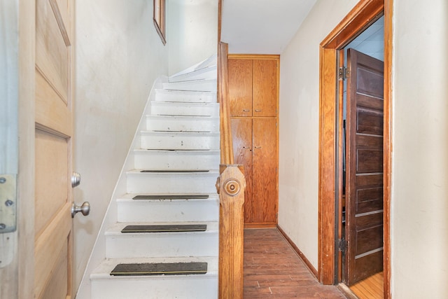 560 Stryker Ave, Saint Paul, MN 55107 - stairs featuring wood finished floors and baseboards