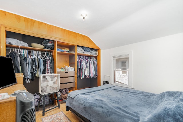560 Stryker Ave, Saint Paul, MN 55107 - bedroom featuring a closet, wood finished floors, and lofted ceiling