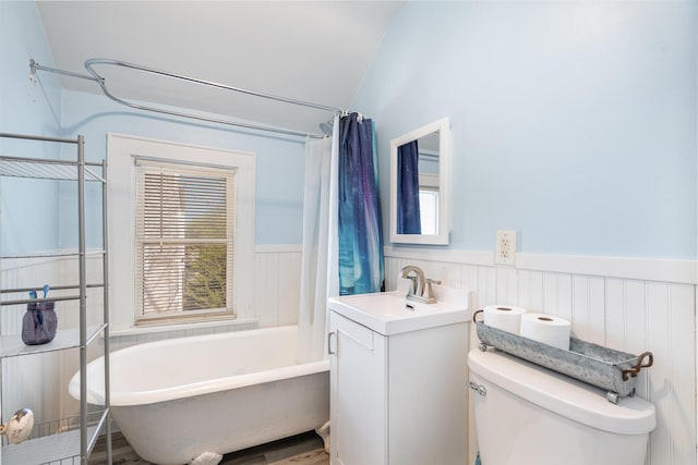 560 Stryker Ave, Saint Paul, MN 55107 - bathroom with toilet, wainscoting, a tub to relax in, vanity, and vaulted ceiling