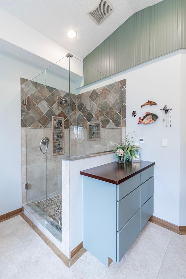 full bathroom with baseboards, tile patterned flooring, a shower stall, and visible vents