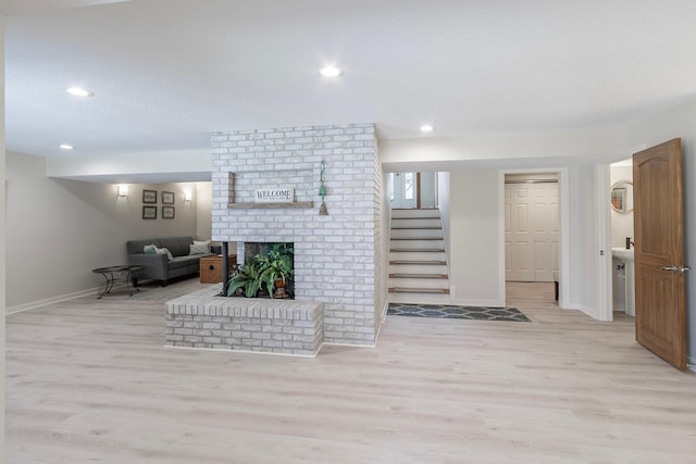 30 Interlachen Ln, Tonka Bay, MN 55331 - living area with stairs, wood finished floors, a fireplace, and recessed lighting