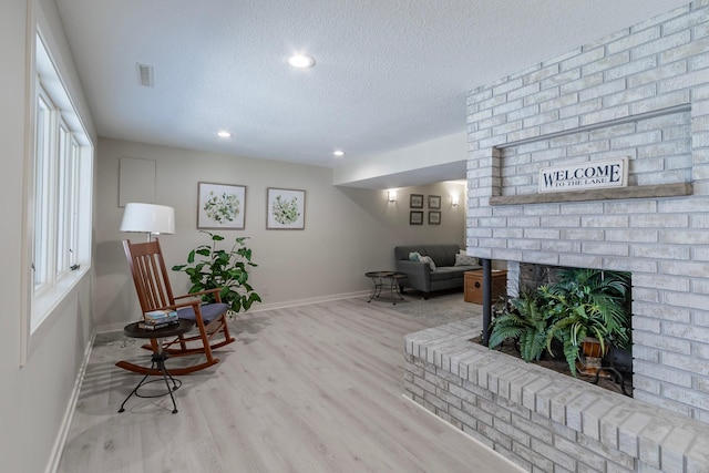 30 Interlachen Ln, Tonka Bay, MN 55331 - living area with a textured ceiling, wood finished floors, recessed lighting, and a fireplace