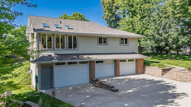 30 Interlachen Ln, Tonka Bay, MN 55331 - view of front of property featuring a garage, concrete driveway, a shingled roof, and a front yard