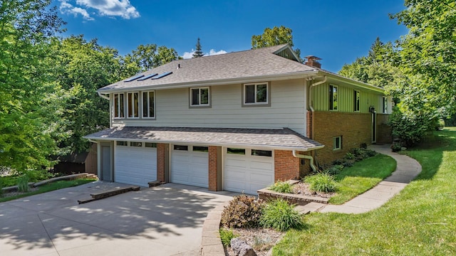 30 Interlachen Ln, Tonka Bay, MN 55331 - view of front of house featuring a chimney, brick siding, concrete driveway, an attached garage, and roof with shingles