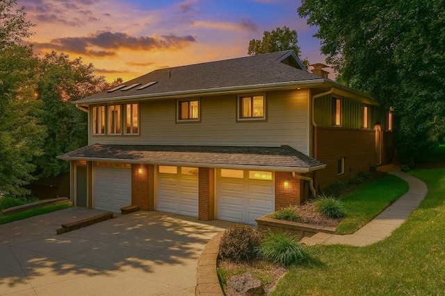 30 Interlachen Ln, Tonka Bay, MN 55331 - view of front facade featuring driveway, an attached garage, a chimney, brick siding, and a front yard