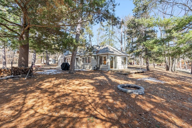 view of front of house featuring a wooden deck and an outdoor fire pit