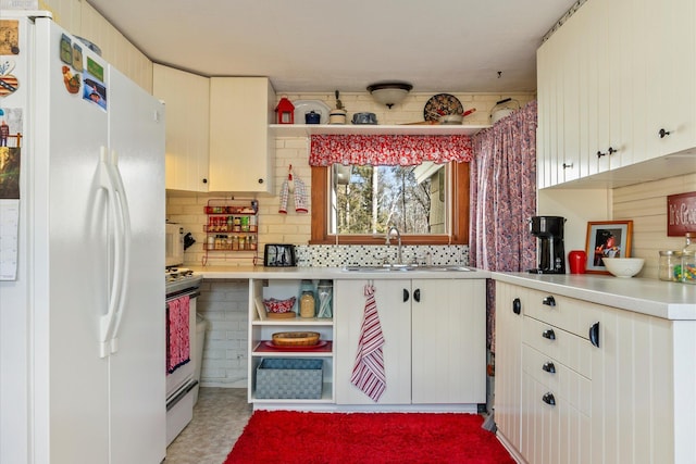 kitchen with white appliances, a sink, light countertops, and tasteful backsplash